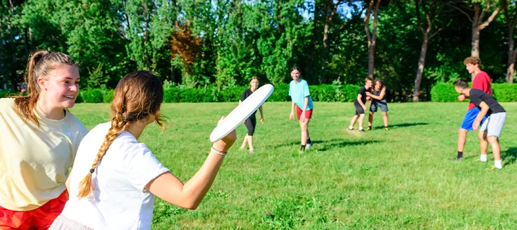 Kids playing frisbee outside